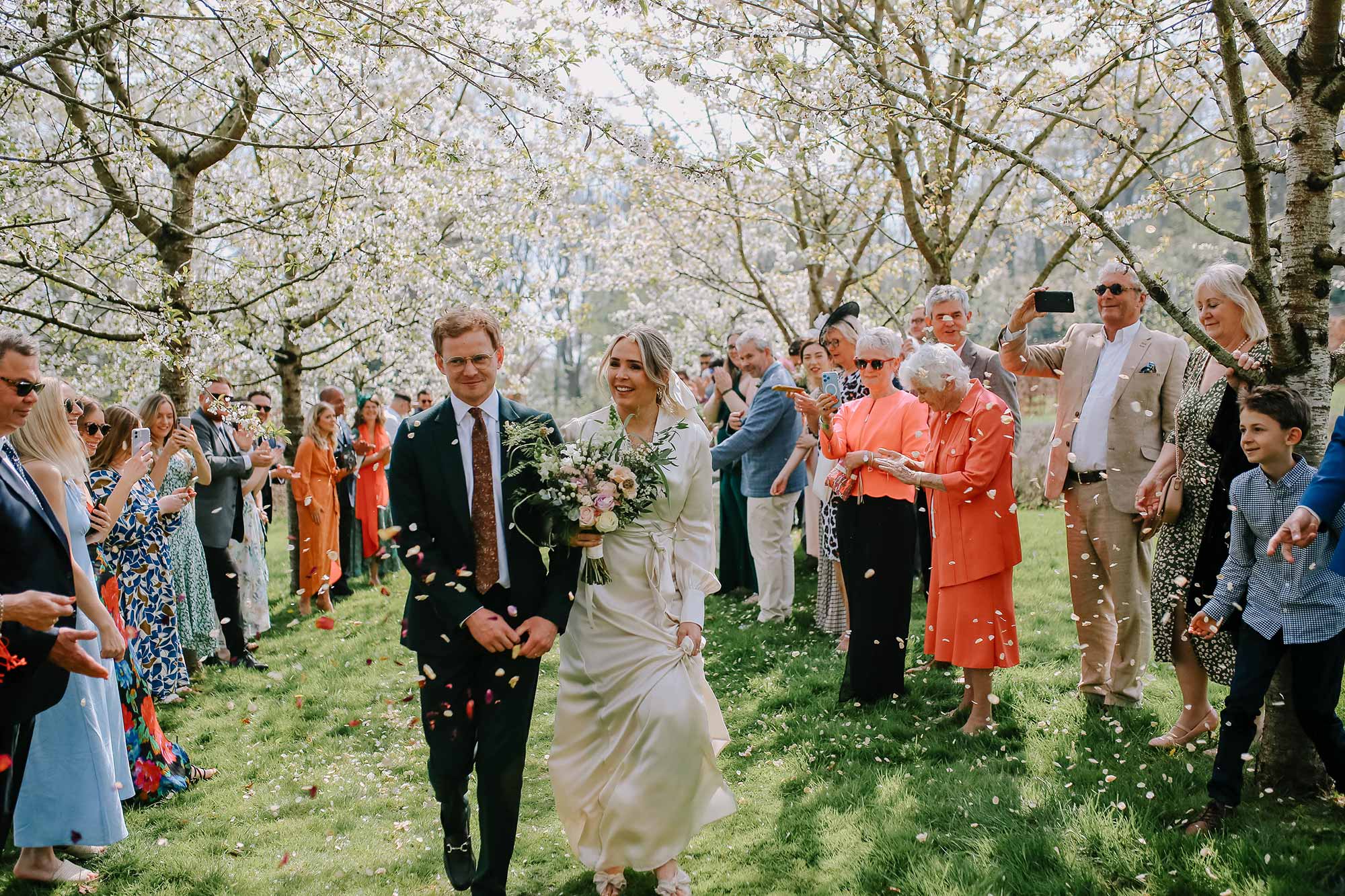 Wedding-couple-confetti-shot-under-Homme-House-blossom