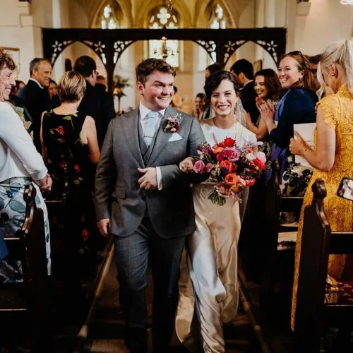 Wedding-couple-leaving-service-at-Yatton-church