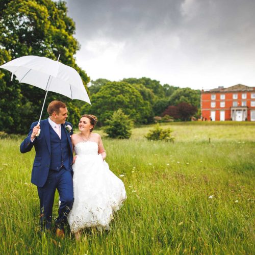 Wedding-couple-portrait-with-umbrella-in-Homme-House-parkland