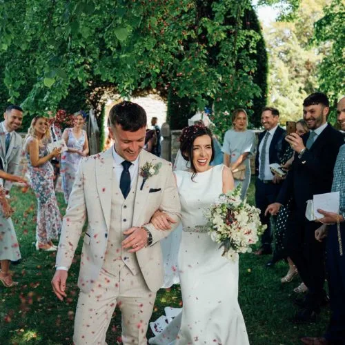 Wedding-couple-showered-with-confetti-after-church-service