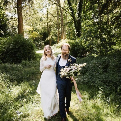 Wedding-couple-walking-Homme-Hose-woodland-path