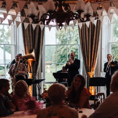 Brass-band-plays-in-front-of-bay-window