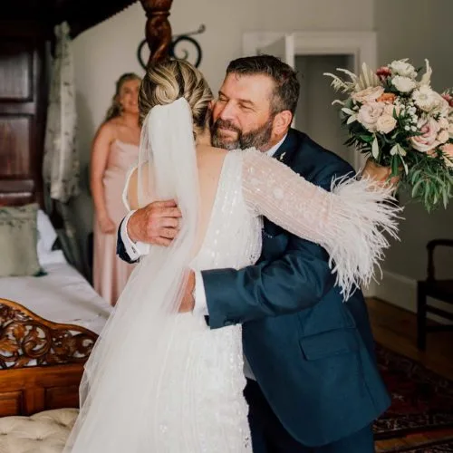 Bride-and-father-embrace-in-Bridal-Suite-at-Homme-House