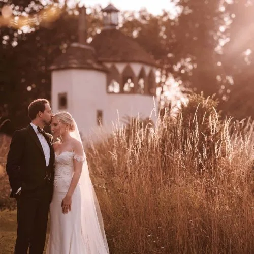 Bride-and-groom-in-evening-sunshine-in-Homme-House-walled-garden