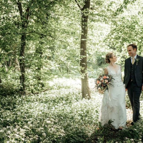 Bride-and-groom-in-wild-garlic-in-woodland-at-Homme-House