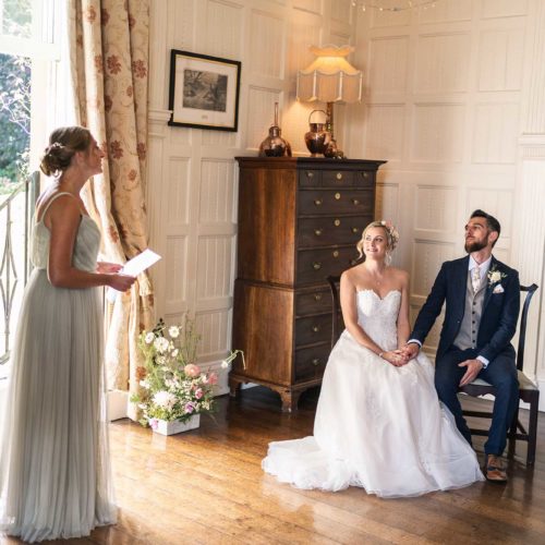Bride-and-groom-listen-to-wedding-reading-in-Panelled-Room-2