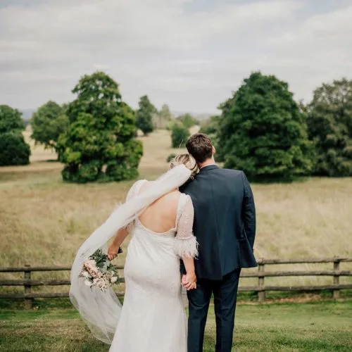Bride-and-groom-looking-out-over-Homme-House-parkland