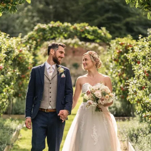 Bride-and-groom-portrait-on-espaliered-apple-tree-walkway