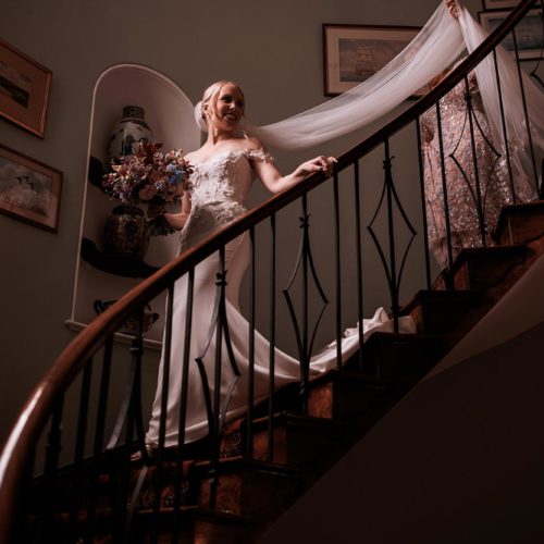Bride-descends-spiral-staircase-at-Homme-House
