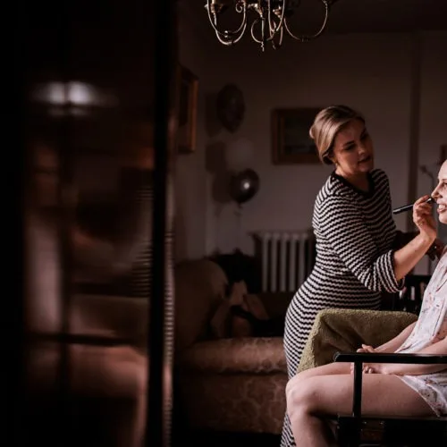Bride-having-make-uo-done-in-front-of-window