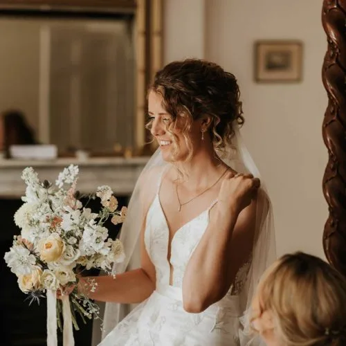 Bride-looks-at-bouquet-in-Bridal-Suite-at-Homme-House