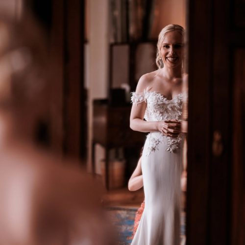 Bride-reflected-in-mirror-in-wedding-dress