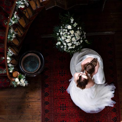 Brides-kiss-under-flying-staircase-at-Homme-House
