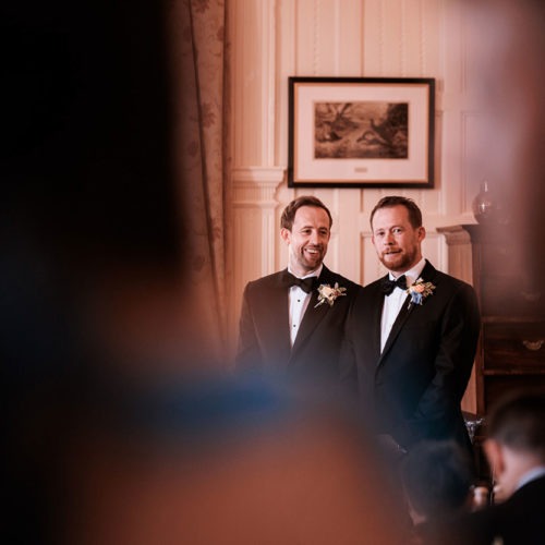 Groom-and-best-man-wait-at-front-of-wedding-ceremony