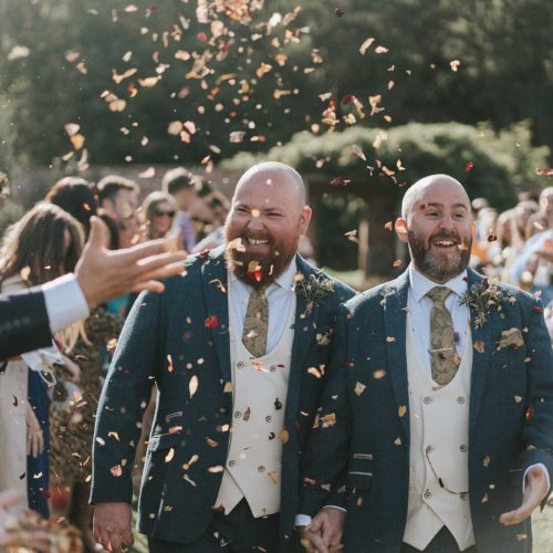 Grooms-showered-with-confetti-in-walled-garden-at-Homme-House