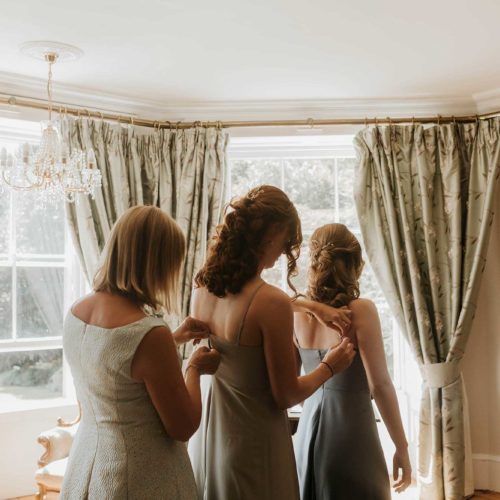 Guests-help-each-other-with-dresses-in-Homme-House-Bridal-Suite