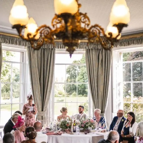 Mother-of-the-bride-giving-a-speech-in-front-of-Homme-House-Dining-Room-bay-window