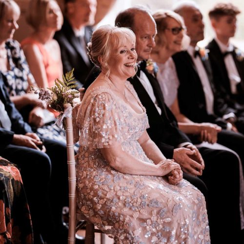 Mother-of-the-bride-laughing-during-wedding-ceremony