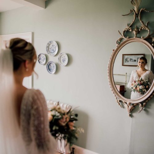 Portrait-of-bride-reflected-in-ornate-Homme-House-mirror