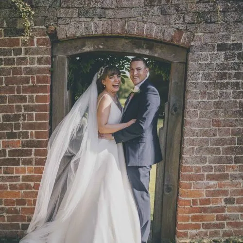Wedding-couple-in-rose-garden-gateway