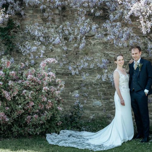 Wedding-couple-under-rose-garden-wisteria