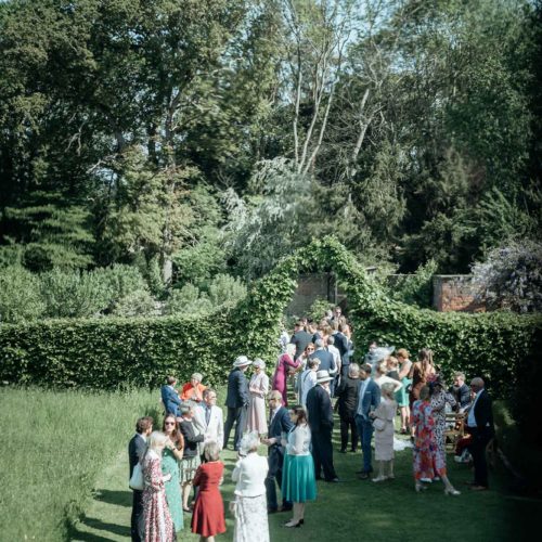 Wedding-guests-at-reception-in-walled-garden-at-Homme-House