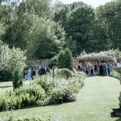 Wedding-guests-in-walled-garden-at-Homme-House