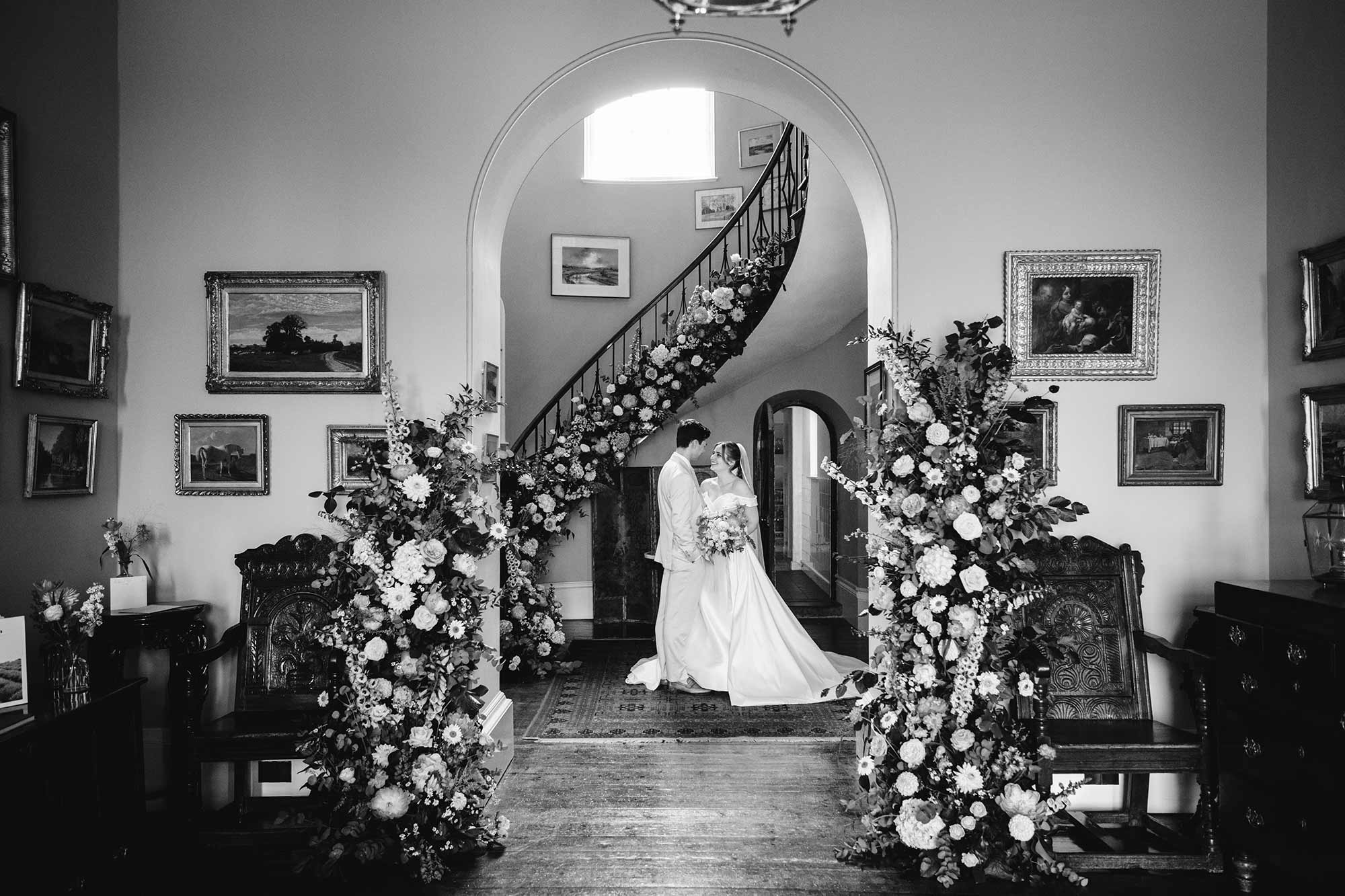 Homme-House-Couple-in-Hall-with-flowers-b&w