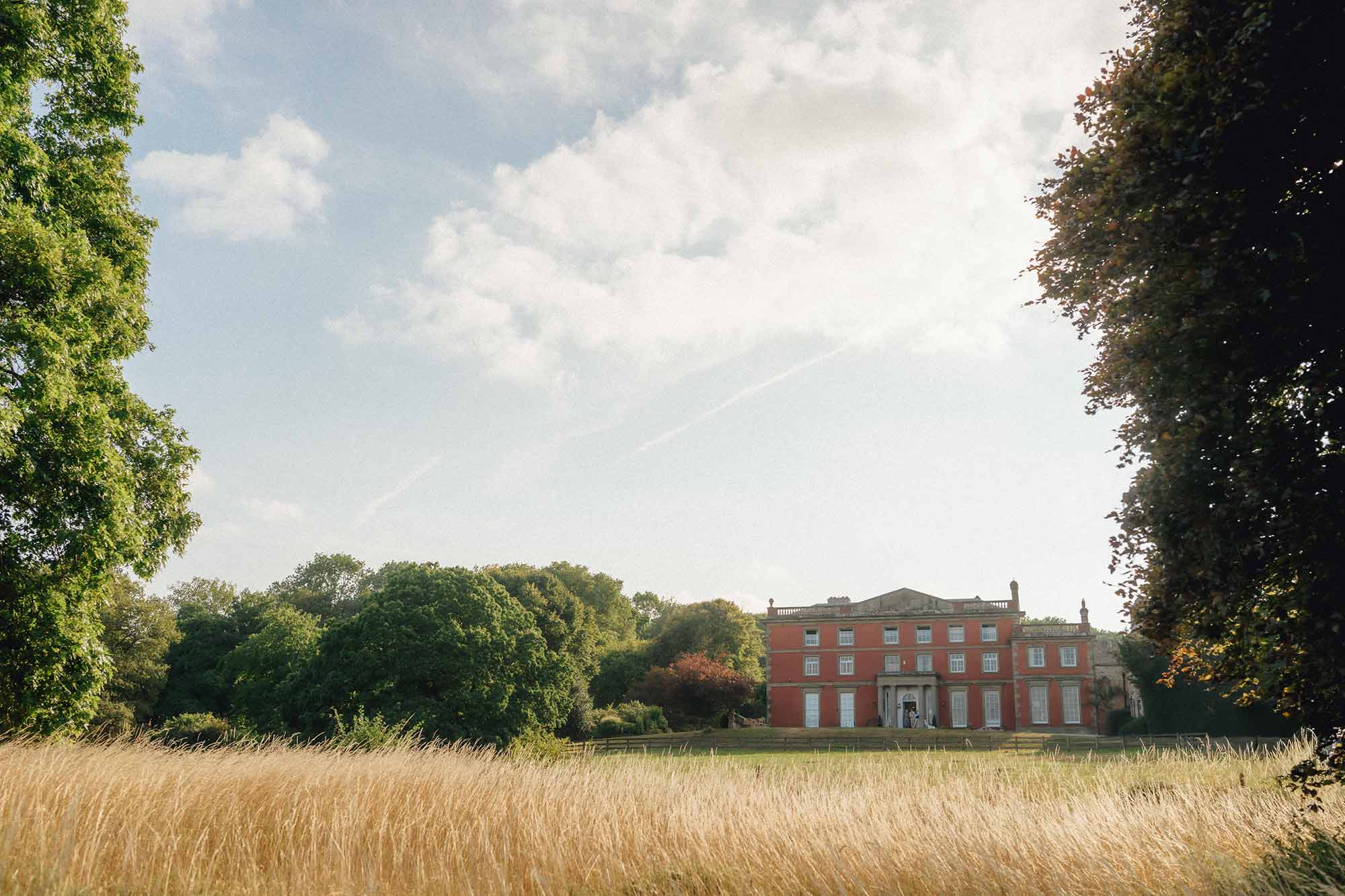 Homme-House-viewed-from-the-long-meadow-grass-of-the-parkland